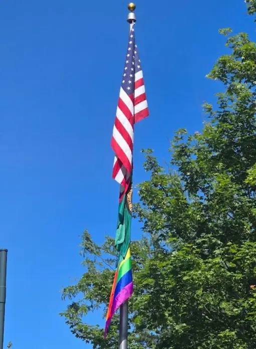 The American flag, Washington flag, and the Pride flag together