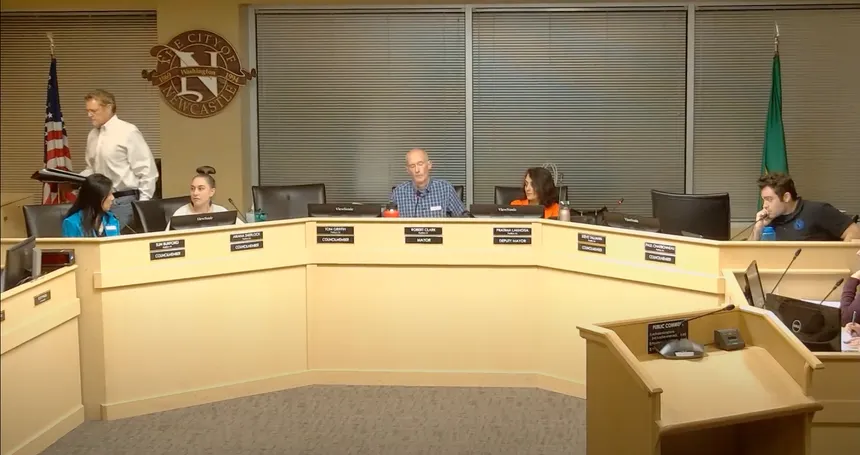 Steve Tallman standing up to leave, while other council members and Mayor Clark remain seated.